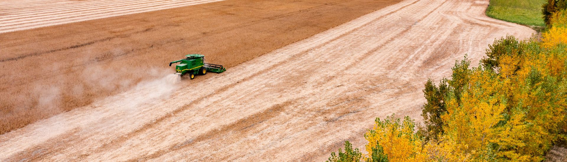 Aerial image of a combine during soybean harvest.