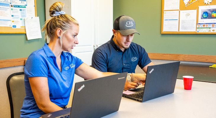 Two people sitting at a computer.